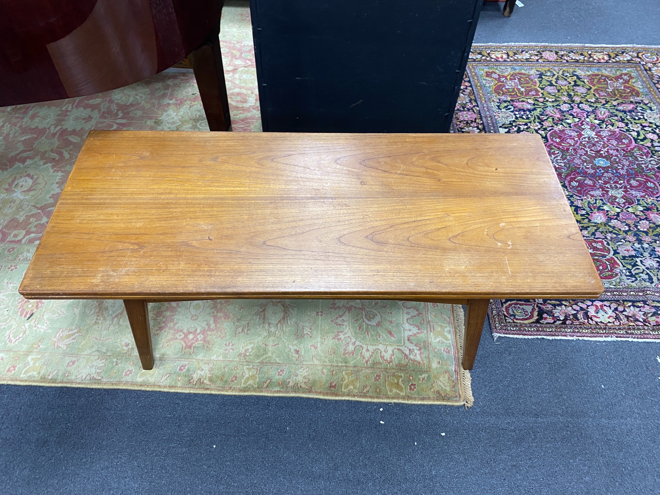 A Danish rectangular teak metamorphic coffee / dining table by Niels Bach, smallest dimensions width 140cm, depth 60cm, height 56cm